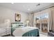 Charming bedroom featuring a bed, balcony access, and natural light at 937 Aztec Dr, Castle Rock, CO 80108