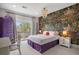 Unique bedroom featuring wallpaper with animal theme and access to a private balcony at 937 Aztec Dr, Castle Rock, CO 80108