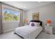 Bright bedroom with a cozy bed, bedside tables, and a picturesque view from the window at 937 Aztec Dr, Castle Rock, CO 80108