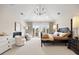 Spacious primary bedroom with a fireplace, balcony access, and luxurious furnishings at 937 Aztec Dr, Castle Rock, CO 80108