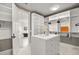 Well-organized walk-in closet with an island dresser with shelves leading to a sleek bathroom at 937 Aztec Dr, Castle Rock, CO 80108