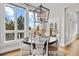 Dining room with modern chandelier, large windows, and views of the outdoors at 937 Aztec Dr, Castle Rock, CO 80108