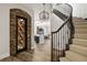 Elegant home entryway showcasing a wine cellar, staircase, and open-concept living area at 937 Aztec Dr, Castle Rock, CO 80108