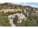 Expansive estate on a lush green golf course with mature trees and beautiful landscaping at 937 Aztec Dr, Castle Rock, CO 80108