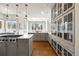 Gourmet kitchen with gray cabinets, quartz countertops, and stainless steel appliances at 937 Aztec Dr, Castle Rock, CO 80108