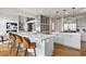 Modern kitchen featuring quartz countertops, gray cabinets, an island, and stainless steel appliances at 937 Aztec Dr, Castle Rock, CO 80108