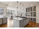 Open kitchen with gray cabinets, quartz countertops, kitchen island, and stainless appliances at 937 Aztec Dr, Castle Rock, CO 80108