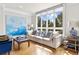 Bright living room featuring large windows, comfortable white sofa, and stylish decor at 937 Aztec Dr, Castle Rock, CO 80108