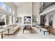 Impressive living room with soaring ceilings, a fireplace, and a sleek, modern design at 937 Aztec Dr, Castle Rock, CO 80108