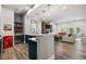 Open-concept living space with a retro Coca-Cola refrigerator, full bar, and comfortable seating at 937 Aztec Dr, Castle Rock, CO 80108