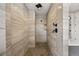 Modern walk-in shower with sleek tile, dual shower heads, and built-in shelving at 937 Aztec Dr, Castle Rock, CO 80108