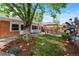 Landscaped backyard with mature trees, patio, and green grass at 40 Colorado Blvd, Denver, CO 80206