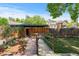 Charming backyard featuring stone pathway, garden beds, and a wooden fence at 40 Colorado Blvd, Denver, CO 80206