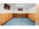 Finished basement with wood paneling and built-in shelving at 40 Colorado Blvd, Denver, CO 80206