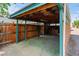 Exterior shot of the covered carport with wooden fence at 40 Colorado Blvd, Denver, CO 80206