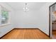 Bright and airy dining room with hardwood floors, chandelier and natural light from a window at 40 Colorado Blvd, Denver, CO 80206