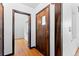 Welcoming entryway featuring hardwood floors, a wood front door with glass detailing, and an arched opening to another room at 40 Colorado Blvd, Denver, CO 80206