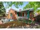 Charming brick home boasts a covered front porch and unique arched detail over the below grade garage access at 40 Colorado Blvd, Denver, CO 80206