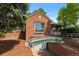 Charming brick home with well-maintained landscaping, a quaint front porch, and a unique arched access to the below grade garage at 40 Colorado Blvd, Denver, CO 80206