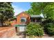 Charming brick home with well-maintained landscaping, a quaint front porch, and a unique arched access to the below grade garage at 40 Colorado Blvd, Denver, CO 80206