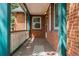 Covered front porch with traditional railings, stained brick columns, and plenty of room for outdoor seating at 40 Colorado Blvd, Denver, CO 80206