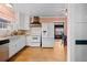 Spacious kitchen with white cabinets, wood countertops, stainless steel refrigerator and eat-in dining space at 40 Colorado Blvd, Denver, CO 80206