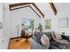 Bright living room with exposed wood beams, hardwood floors, and comfortable seating near large windows at 40 Colorado Blvd, Denver, CO 80206