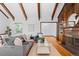 Open living room with hardwood floors, wood beam ceiling, and a fireplace at 40 Colorado Blvd, Denver, CO 80206