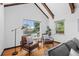 Bright living room with hardwood floors, exposed wood beam ceiling, and large windows offering plenty of natural light at 40 Colorado Blvd, Denver, CO 80206