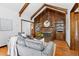 Inviting living room featuring hardwood floors, a fireplace with built-in shelves, and exposed wood beams at 40 Colorado Blvd, Denver, CO 80206