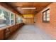 Spacious sunroom with wood paneling, brick walls, and lots of windows at 40 Colorado Blvd, Denver, CO 80206