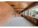 Spacious sunroom featuring brick walls, carpet, and wood ceiling at 40 Colorado Blvd, Denver, CO 80206