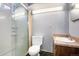 Bathroom featuring a shower, toilet, and vanity cabinet at 6185 Sheridan Blvd, Arvada, CO 80003