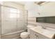 Bathroom features a glass-enclosed shower, toilet, sink with vanity, and unique vintage pink and white tile at 6185 Sheridan Blvd, Arvada, CO 80003