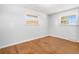 Bedroom with hardwood floors and two windows providing natural light at 6185 Sheridan Blvd, Arvada, CO 80003