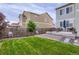 A lush, green backyard featuring a patio with outdoor furniture, a barbecue, and a cozy gazebo at 6883 E 132Nd Pl, Thornton, CO 80602