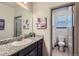 Bathroom featuring a granite countertop, a large mirror, and a view into the toilet room at 6883 E 132Nd Pl, Thornton, CO 80602