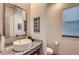 Half bathroom with granite countertops, a vessel sink, and decorative wall art at 6883 E 132Nd Pl, Thornton, CO 80602