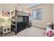 A charming bedroom with a bunk bed, a comfortable beanbag, and natural light from the window at 6883 E 132Nd Pl, Thornton, CO 80602