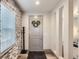 The entryway features luxury vinyl plank floors and stone accent wall at 6883 E 132Nd Pl, Thornton, CO 80602