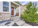 Charming entryway of home features a stone facade and covered porch at 6883 E 132Nd Pl, Thornton, CO 80602