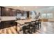 Modern kitchen features dark wood cabinets, an island, and stainless appliances at 6883 E 132Nd Pl, Thornton, CO 80602