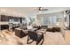 Open concept living room with dark cabinets and luxury vinyl plank flooring at 6883 E 132Nd Pl, Thornton, CO 80602
