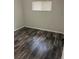 Neutral bedroom with hardwood floors and natural light from the window at 9041 Lilly Ct, Thornton, CO 80229