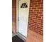 Arched white front door nestled in a classic red brick facade at 9041 Lilly Ct, Thornton, CO 80229