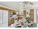 Eat in kitchen with light wood cabinetry and a dining nook at 12165 Monaco Dr, Brighton, CO 80602