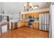 Bright kitchen with stainless steel appliances and wood flooring at 6143 Gorham St, Frederick, CO 80530