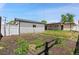 View of the backyard with a white fence, small storage shed and garden at 741 S 6Th Ave, Brighton, CO 80601