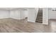Open basement area with stairs, neutral walls, and vinyl floors, perfect for customization at 741 S 6Th Ave, Brighton, CO 80601