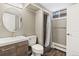 Chic bathroom with wood-look vanity, modern sink, and updated shower with neutral tones at 741 S 6Th Ave, Brighton, CO 80601